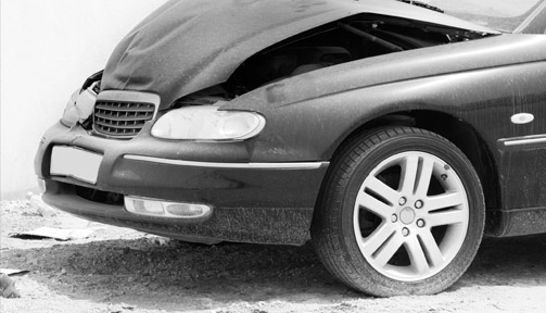 A damaged black sedan with an open, crumpled hood indicating a front-end collision.